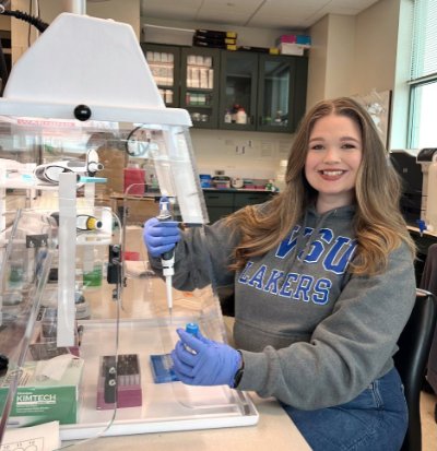 Keely Dunham poses while working at a genetics lab bench.